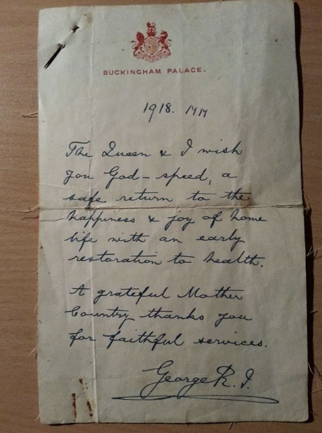 A handwritten letter from 1918 sent by Buckingham Palace, expressing gratitude and well-wishes for a safe return and restored health, signed "George R.I."
