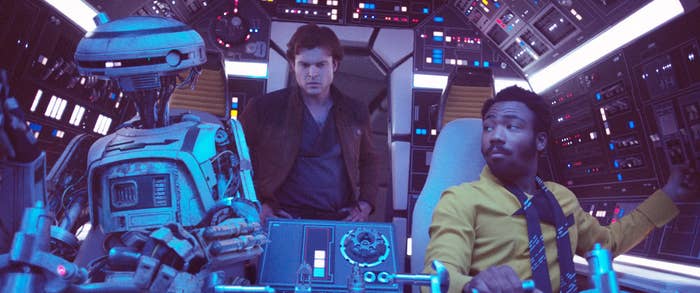 L3-37, Alden Ehrenreich as Han Solo, and Donald Glover as Lando Calrissian in the cockpit of the Millennium Falcon, scene from "Solo: A Star Wars Story."