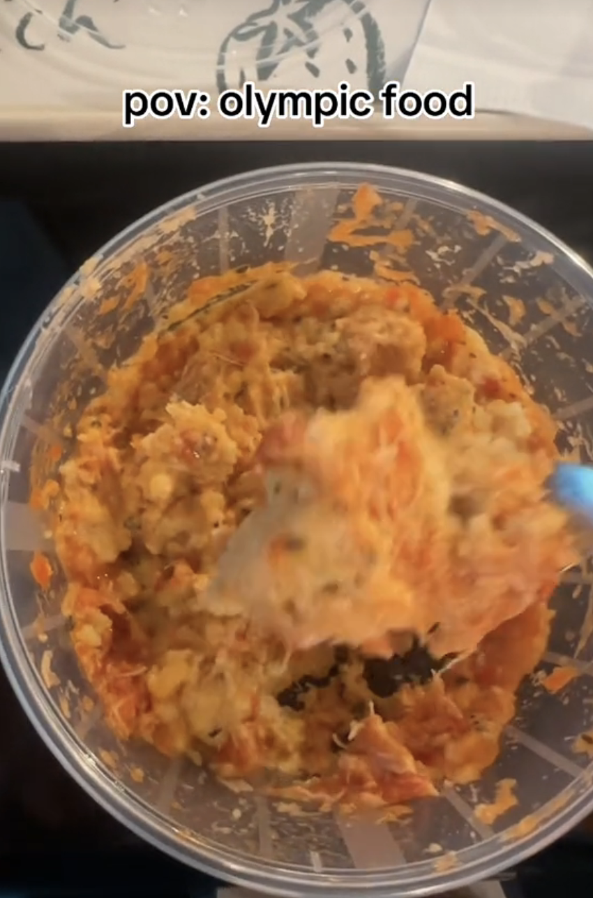 A container filled with a mix of food, labeled "pov: olympic food."