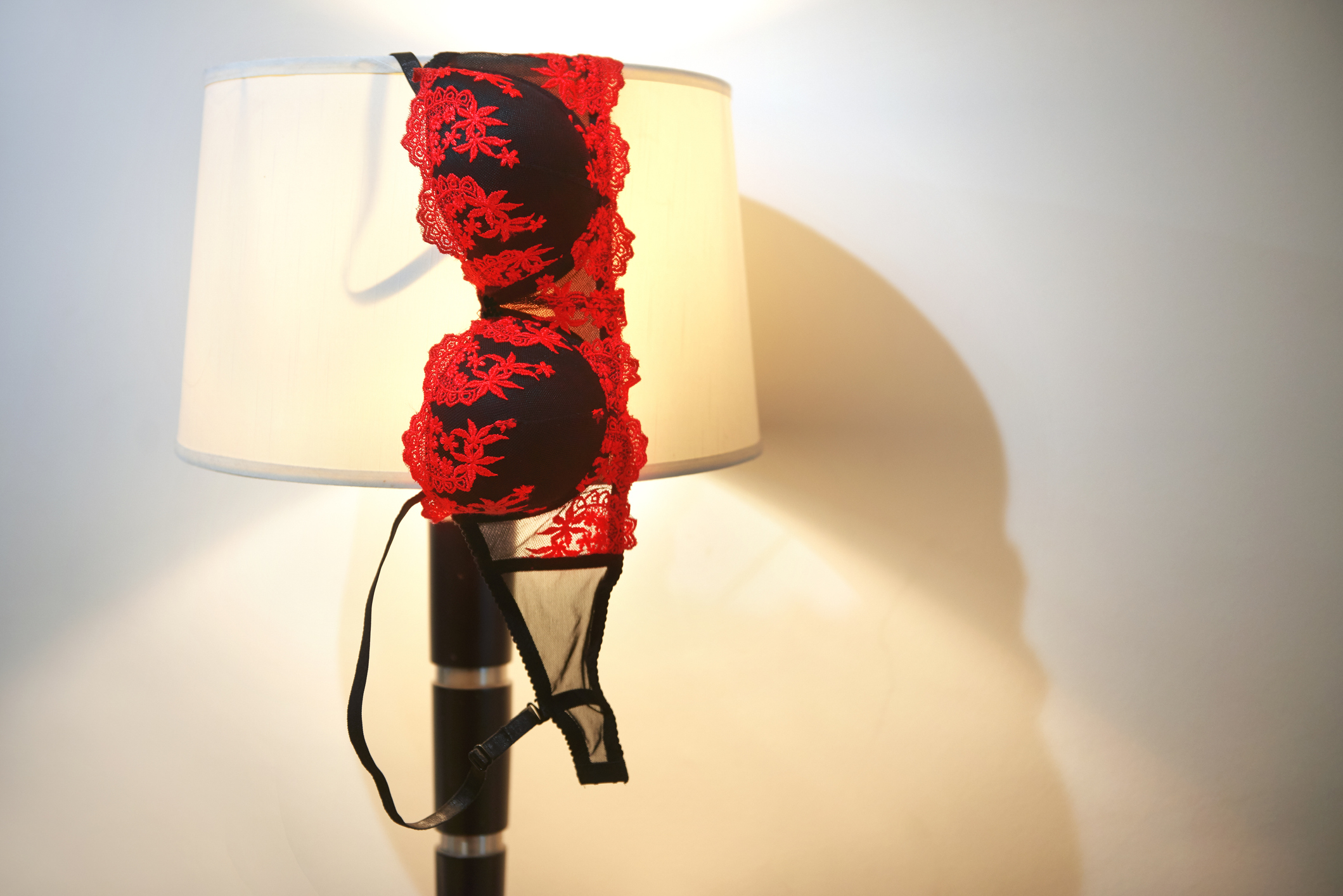 Lace bra draped over a lampshade