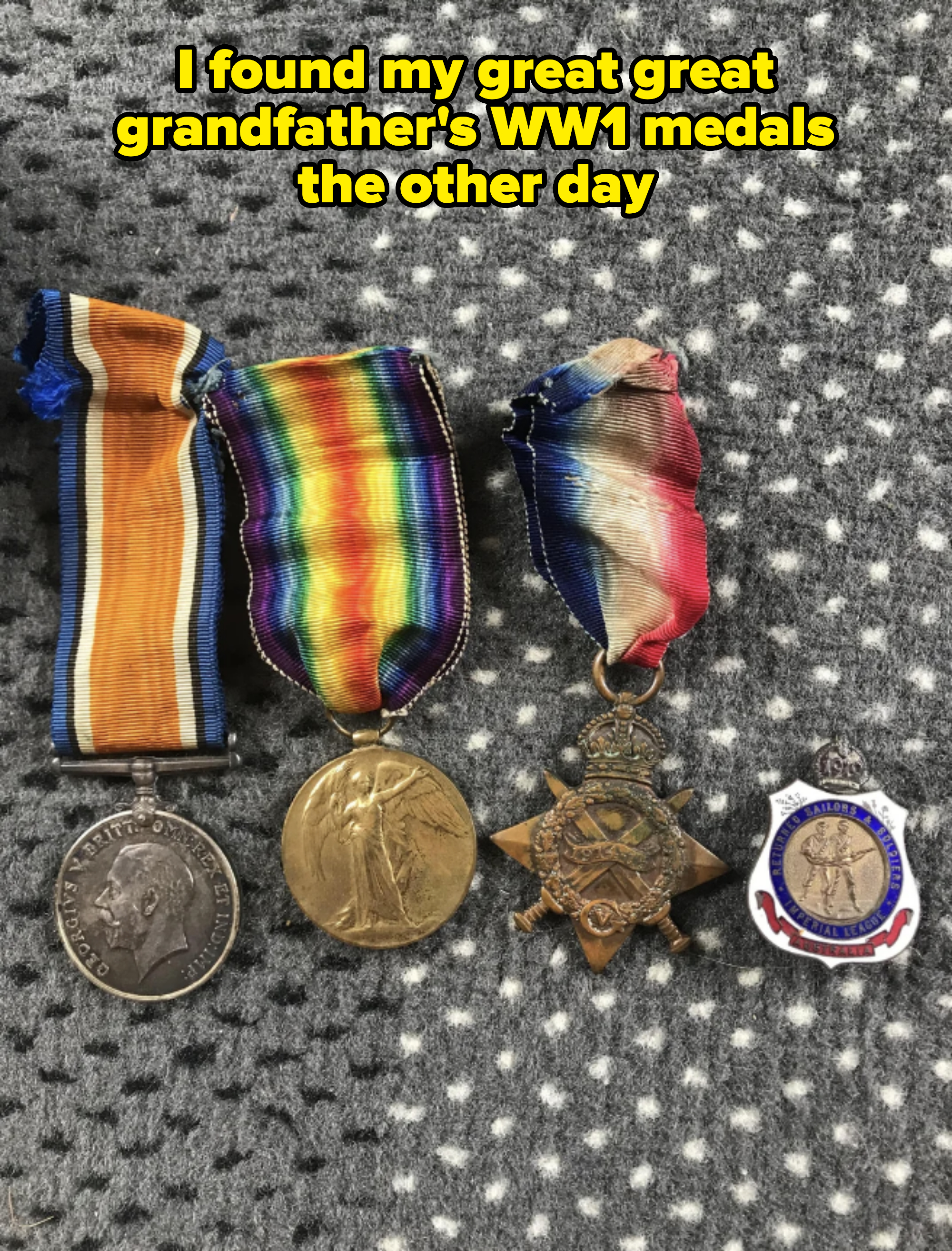 Four World War I medals displayed on a gray surface: a British War Medal, a Victory Medal, a 1914-15 Star, and a South African Police Service badge