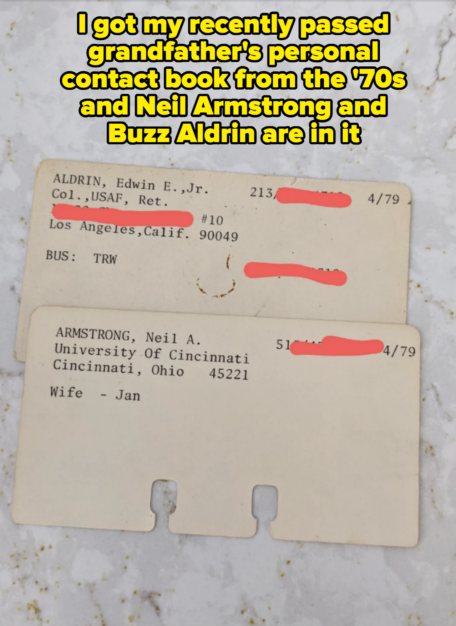 Two white paper identification cards. Text includes names: Edwin E. Aldrin Jr., Neil A. Armstrong. Other text includes addresses and affiliations