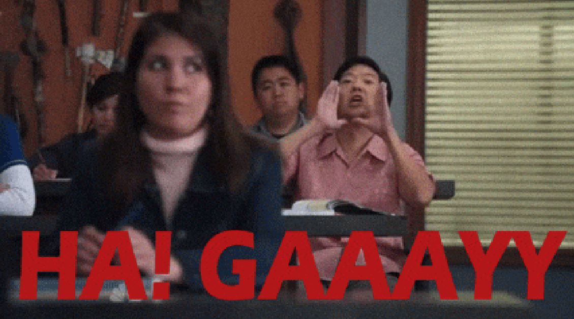 Ken Jeong in a classroom scene yelling "HA! GAAAYYY" with students seated at desks in the background