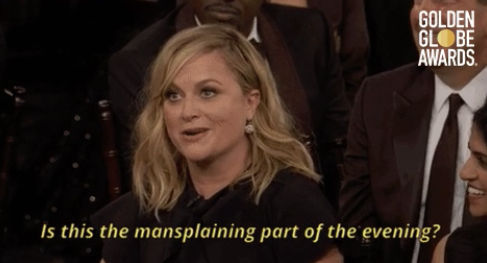 Amy Poehler speaking and smiling during the Golden Globe Awards with text overlay saying, "Is this the mansplaining part of the evening?"