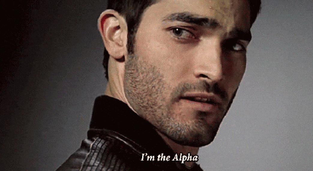 Actor looking serious, turning towards the camera with text overlay "I'm the Alpha."