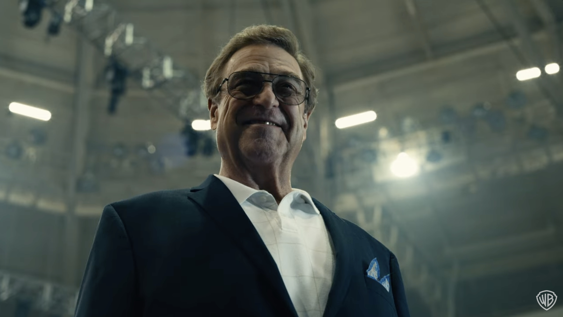 John Goodman smiling in a jacket and button-up shirt in a scene from "The Righteous Gemstones"
