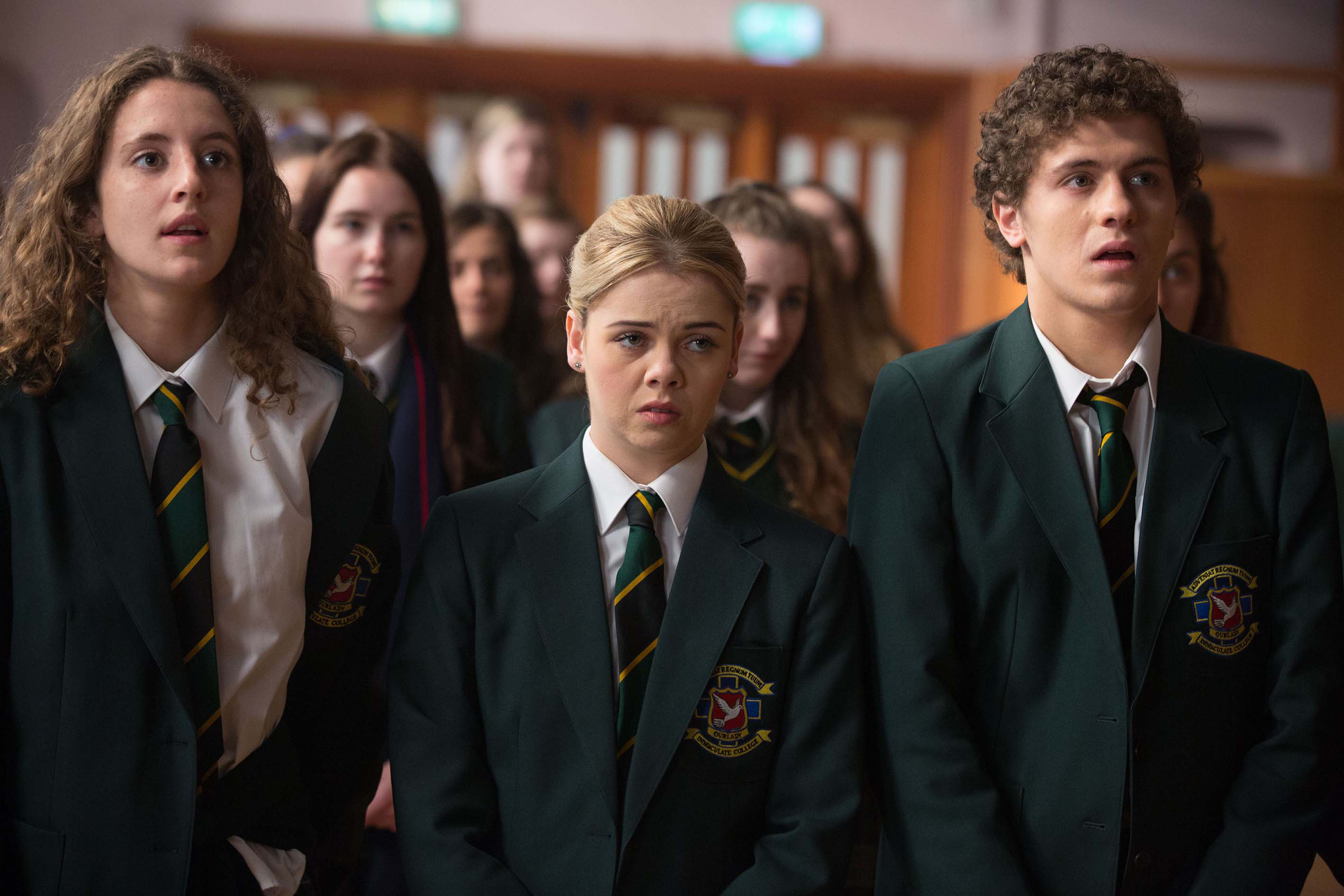 Louisa Harland, Saoirse Jackson, and Dylan Llewellyn in school uniforms in a scene from "Derry Girls"