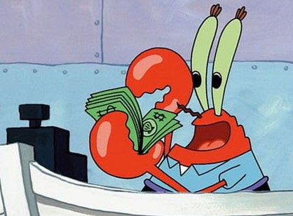 Mr. Krabs from "SpongeBob SquarePants" happily holds a stack of money while sitting at a desk