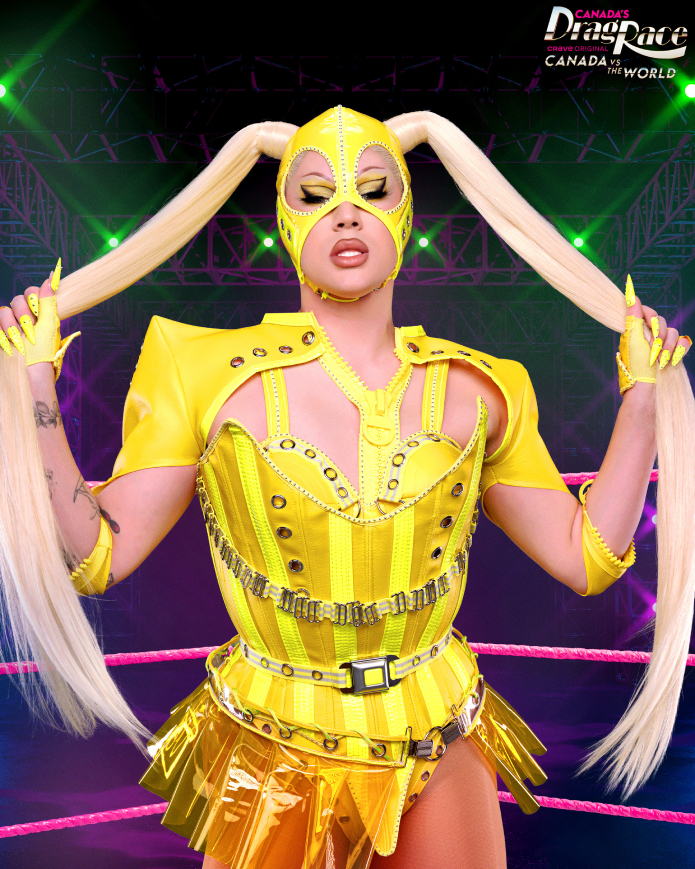 Drag queen in a futuristic costume with ponytail extensions poses on stage for Canada's Drag Race: Canada vs. the World
