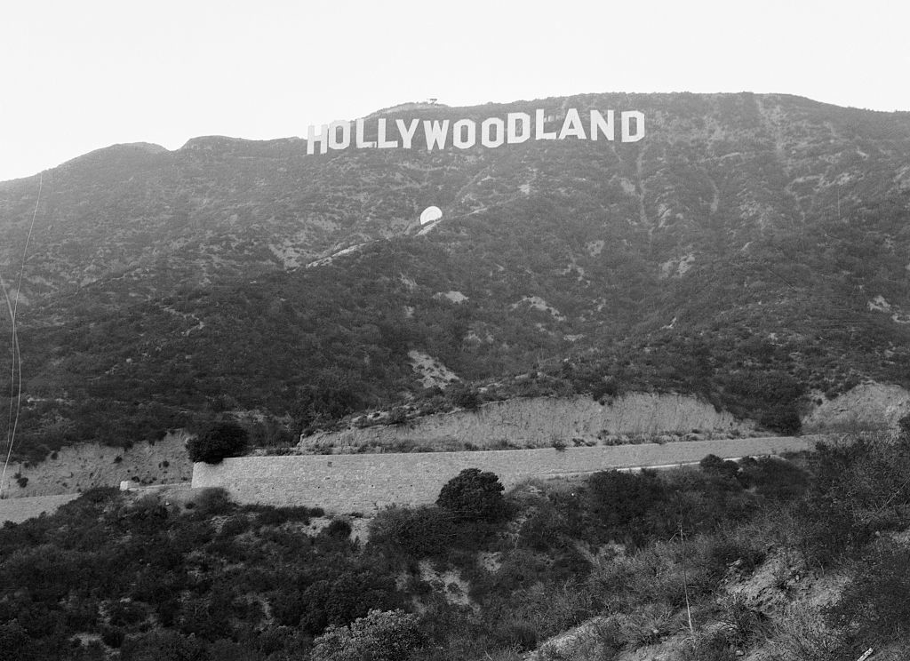 Black and white image of the original "Hollywoodland" sign on the hillside in Los Angeles, CA