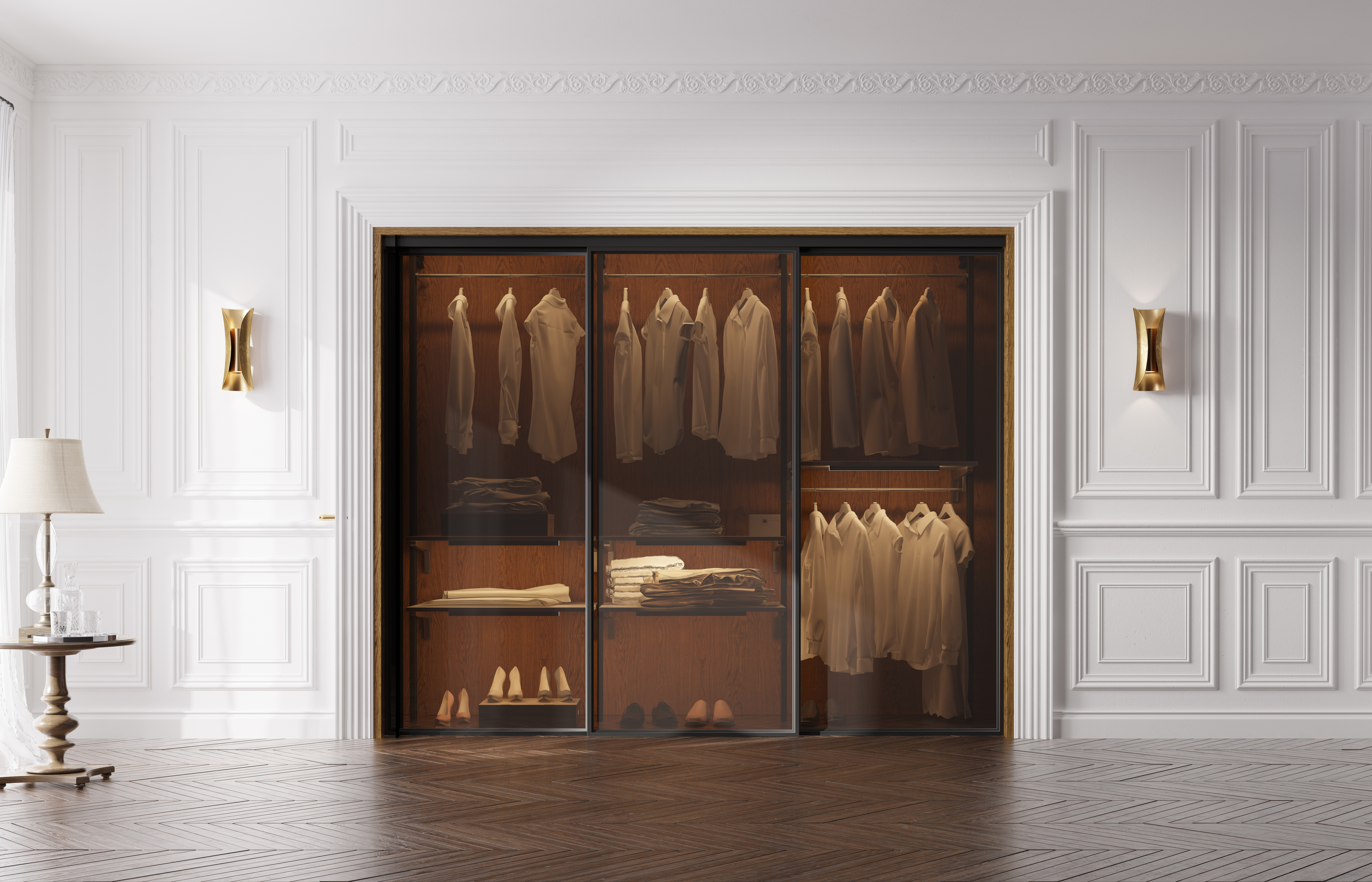 A stylish, luxurious walk-in closet with neatly arranged shirts, pants, and shoes in a sophisticated room with elegant moldings and wooden floors