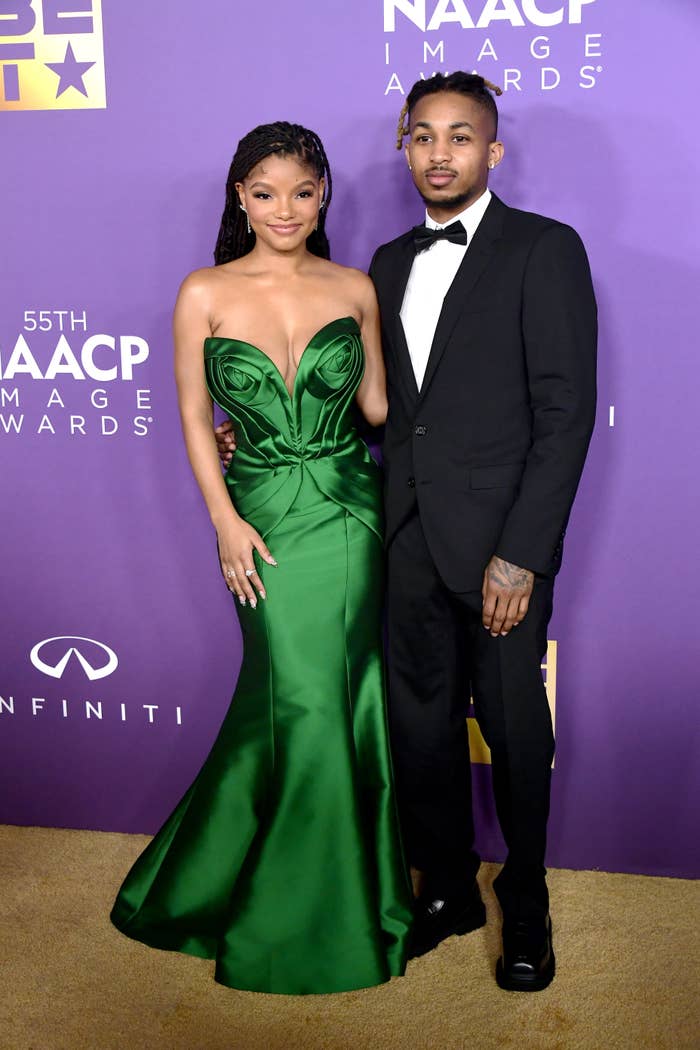 Halle Bailey, in a strapless green gown, and DDG, in a black tuxedo, pose together at the 55th NAACP Image Awards