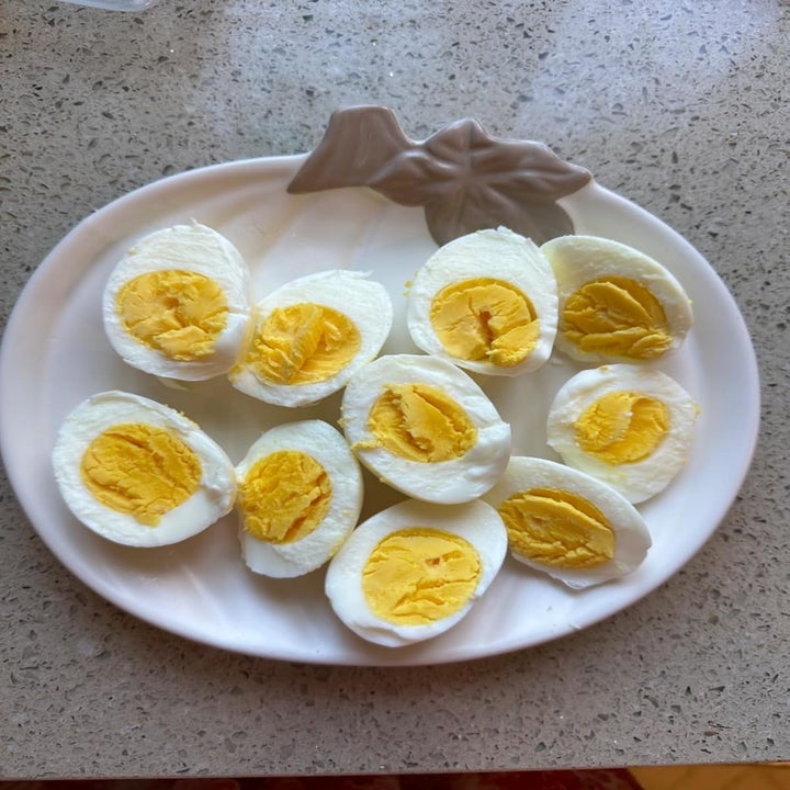 A plate with ten halves of hard-boiled eggs, displaying their yolks and whites