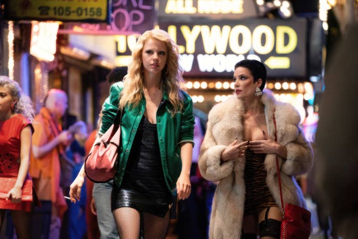 Mia Goth and Halsey walking on a street together in a scene from "MaXXXine"