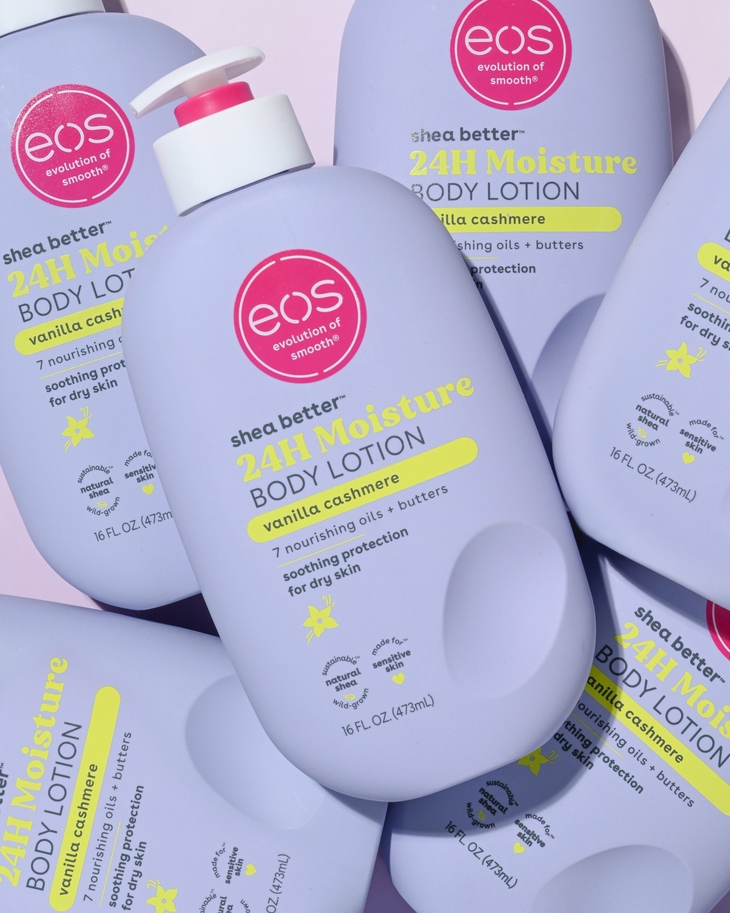 Various bottles of EOS 24H Moisture Body Lotion in Vanilla Cashmere scent placed together. Each bottle highlights features like 7 nourishing oils
