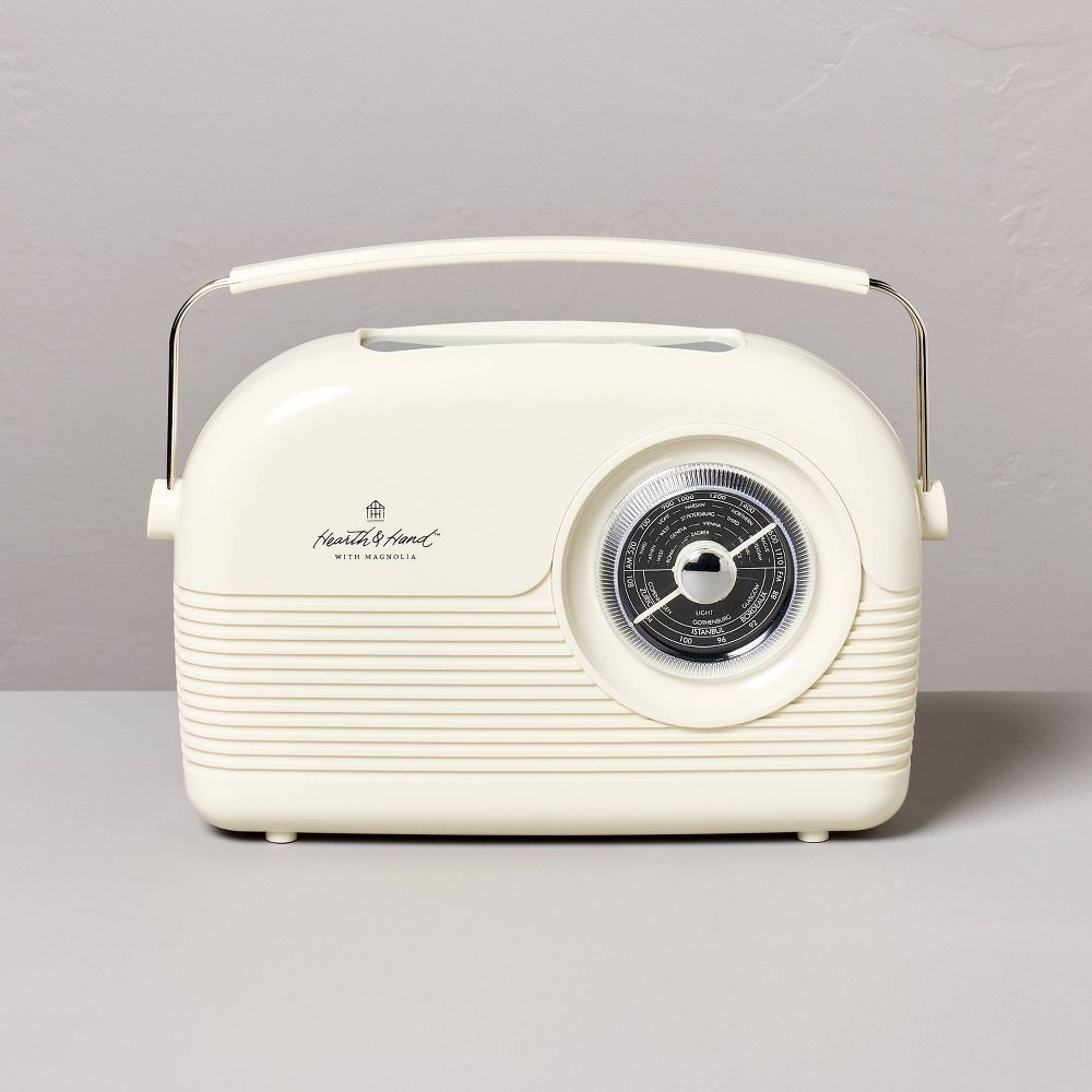 A retro-style Heath & Home radio with a dial tuner and built-in handle on a plain surface