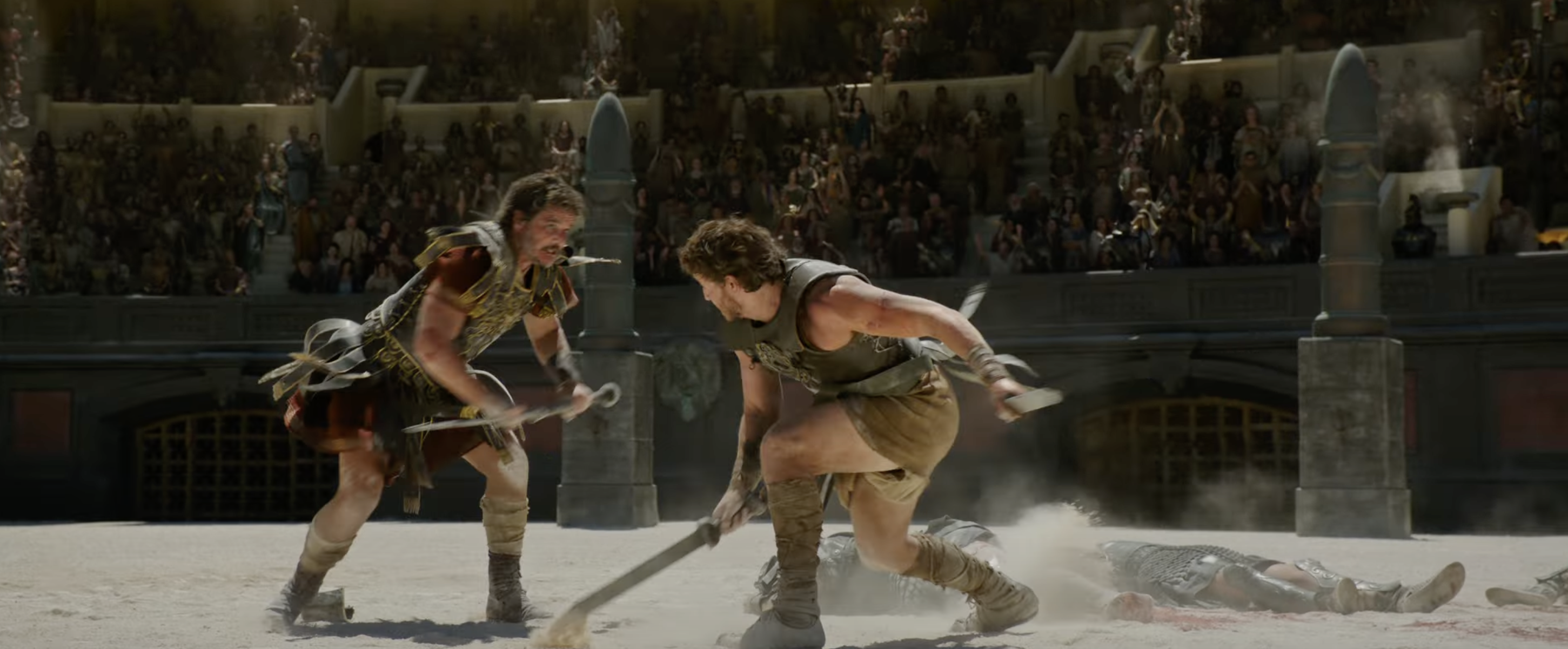 Two gladiators fight in an ancient arena, surrounded by spectators. One combatant aggressively swings a weapon while another defends on the ground