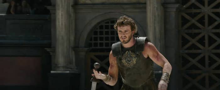 Paul Mescal in ancient warrior attire during a battle scene