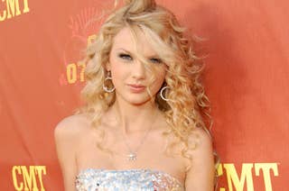 Taylor Swift on the red carpet in a strapless, sequined dress at a CMT event