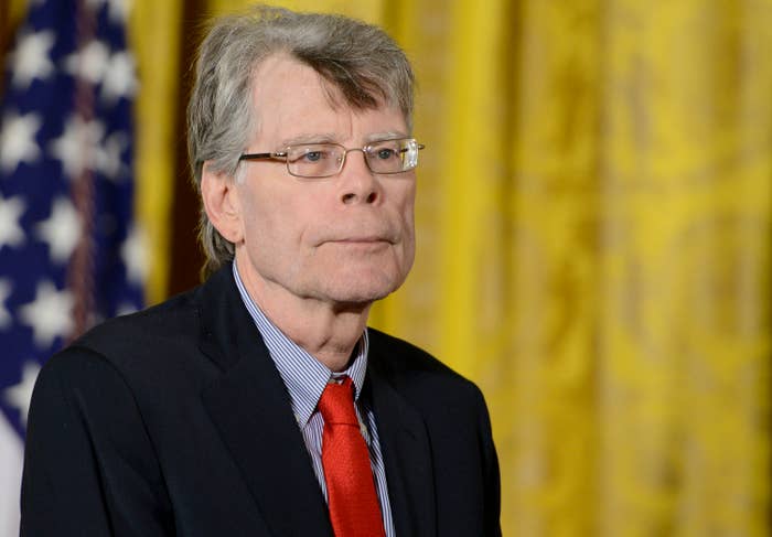 Stephen King in a suit and red tie at an event