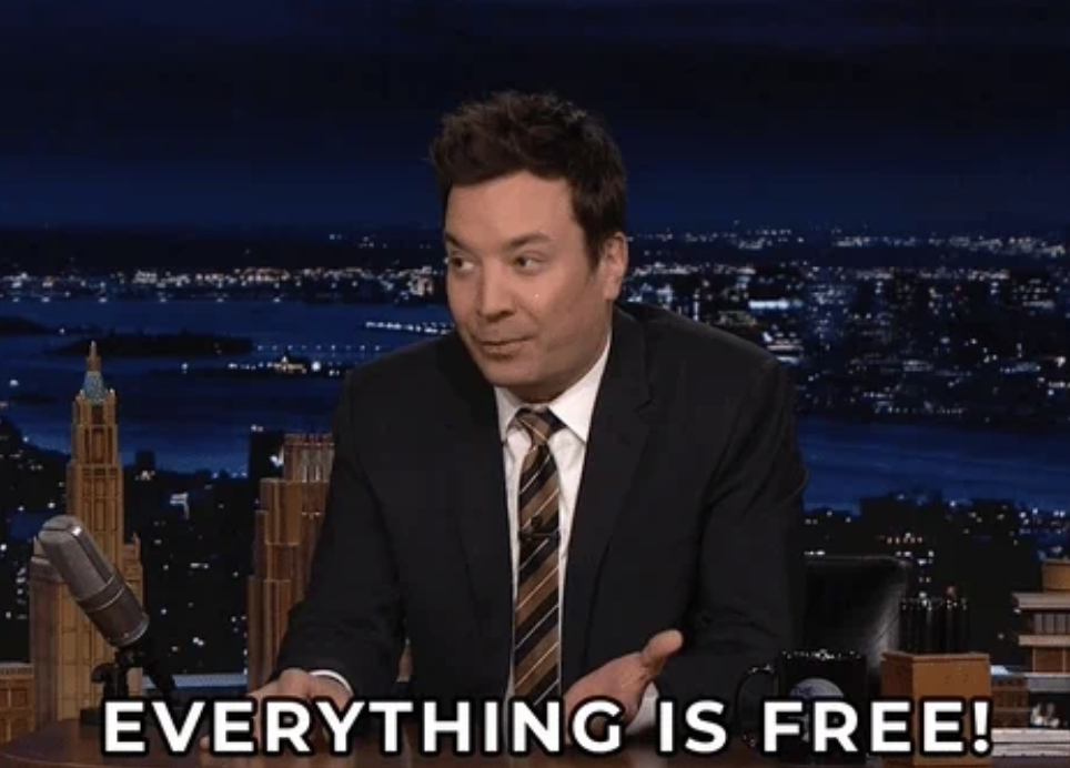 Jimmy Fallon on a talk show set with city skyline in the background. Text overlaid at the bottom reads, &quot;EVERYTHING IS FREE!&quot;