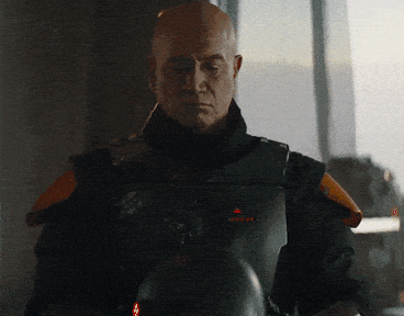 Temuera Morrison as Boba Fett, holding his helmet in a scene from "The Book of Boba Fett."