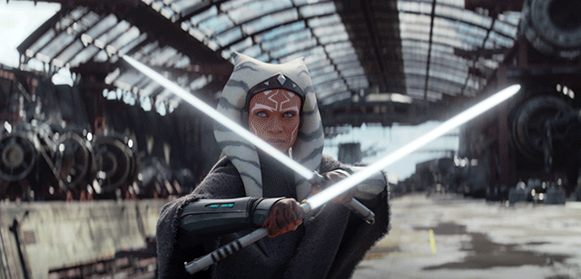 Ahsoka Tano, in an industrial setting, wields two lightsabers in an official image for "Star Wars: Ahsoka" series on Disney+