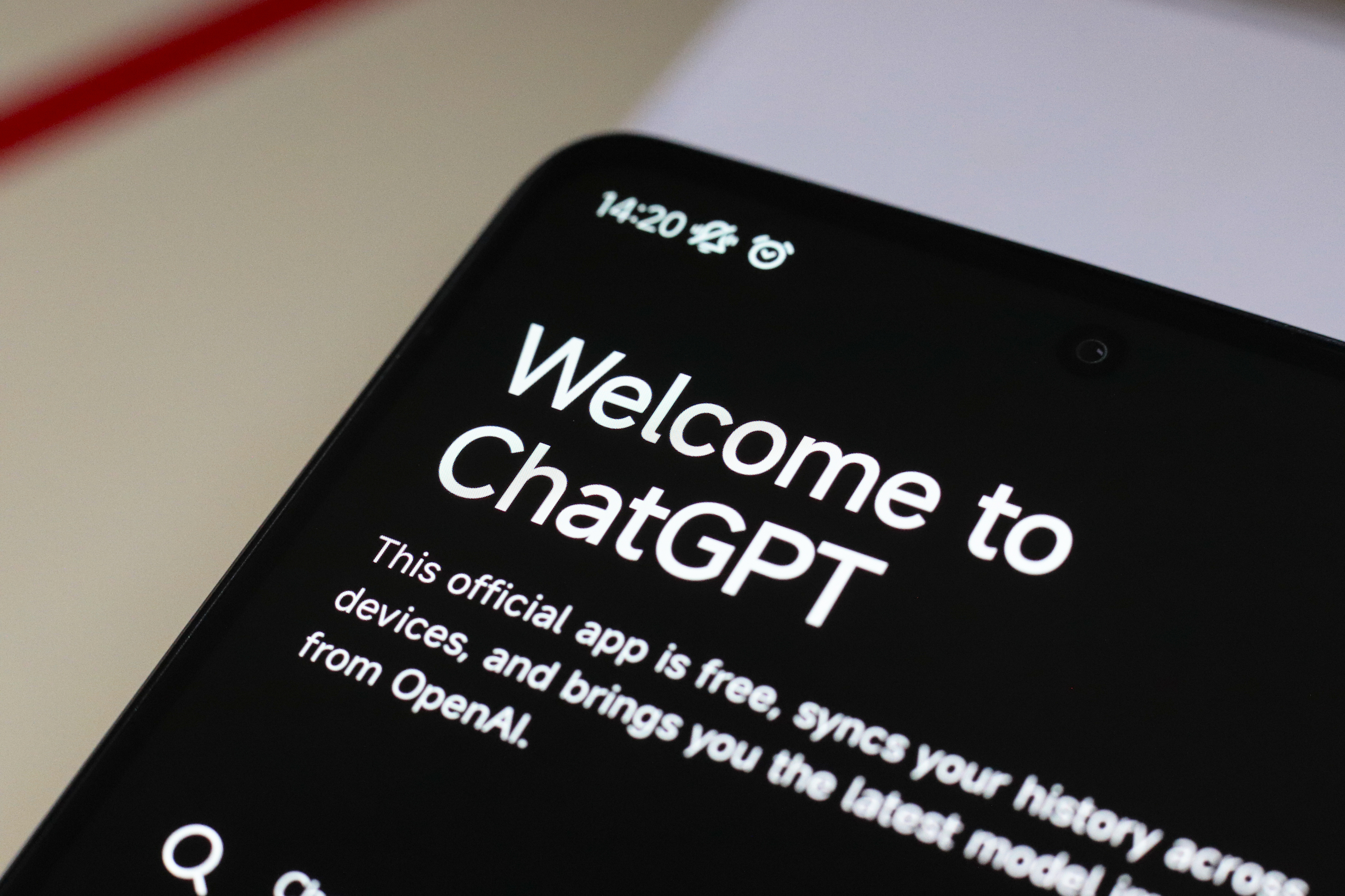 Close-up of a smartphone displaying the ChatGPT app's welcome screen, highlighting the app's features and availability from OpenAI