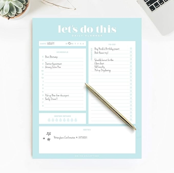 Daily planner showing a to-do list, schedule, hydration tracker, and notes, with a pen on it; includes tasks like grocery shopping and birthday reminders