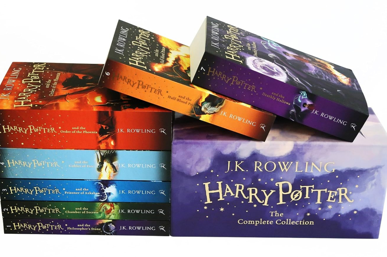 The complete collection of the &quot;Harry Potter&quot; series by J.K. Rowling, featuring all seven books stacked and displayed in a themed box