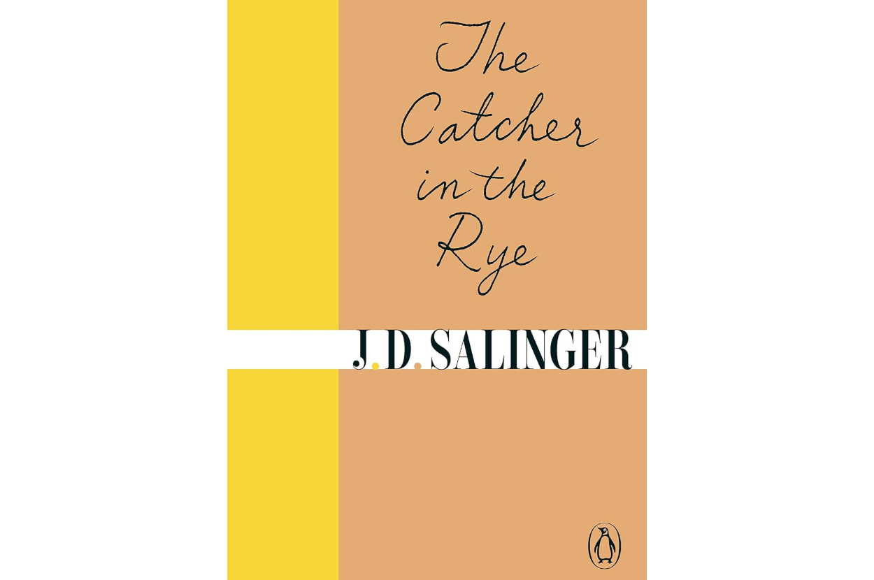 The book cover of &quot;The Catcher in the Rye&quot; by J.D. Salinger. The title is written in a handwritten style above the author's name, with a simple, minimalist design