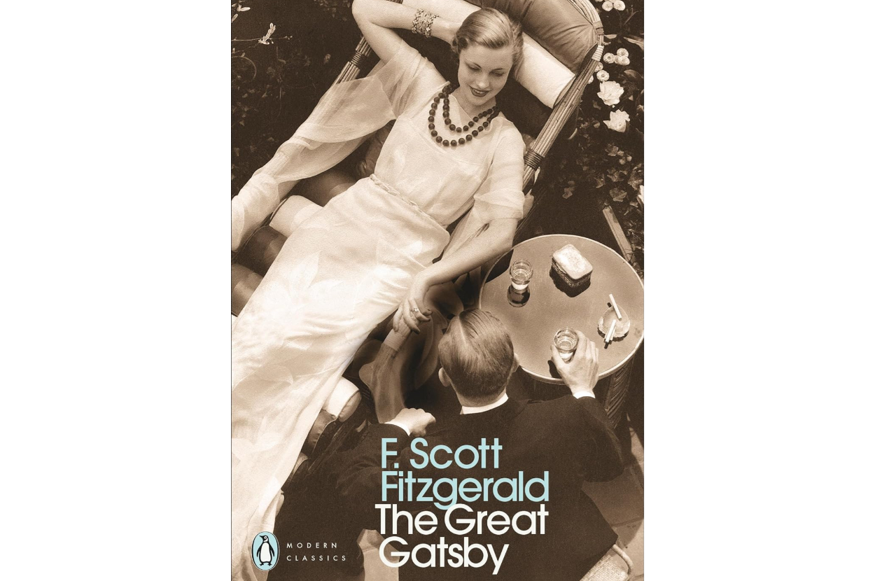 Book cover for &quot;The Great Gatsby&quot; by F. Scott Fitzgerald featuring a stylishly dressed woman lounging and a man in formal attire, both in an elegant setting