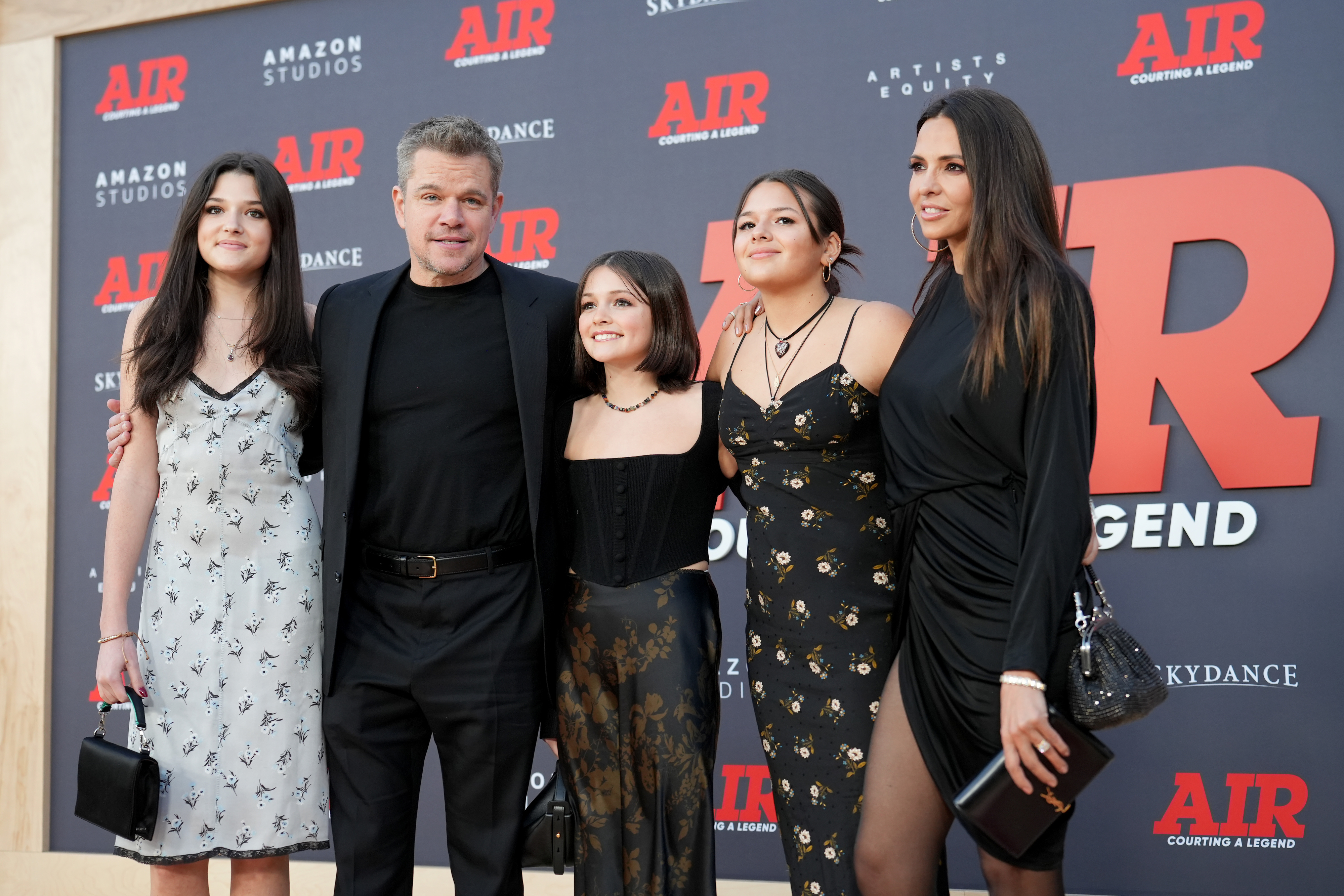 Matt Damon and his wife Luciana Barroso pose with their three daughters at the "AIR" premiere. All are dressed in stylish, semi-formal attire