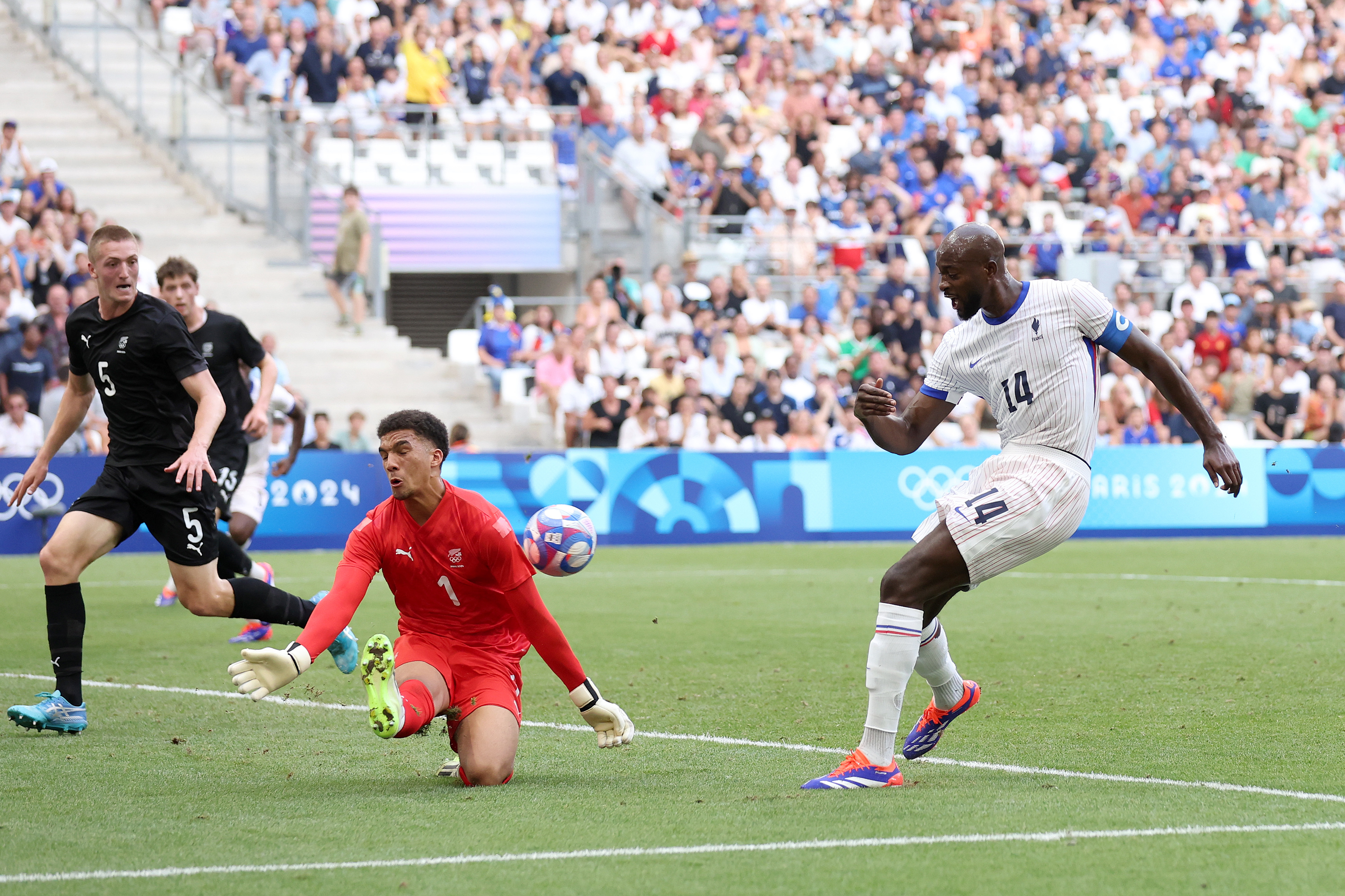 Soccer match action: France's Marcus Thuram attempts a goal against New Zealand with goalkeeper Michael Woud and defender Nando Pijnaker in defensive positions
