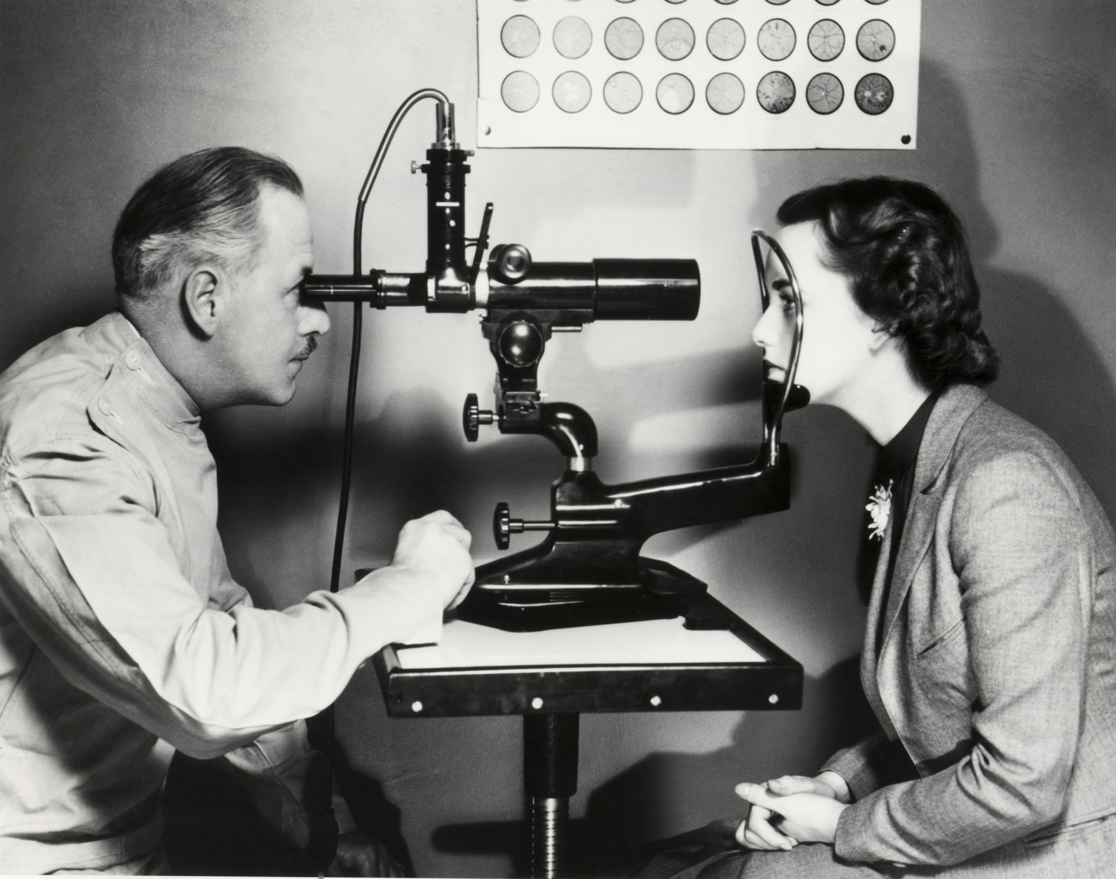 Man and woman during an eye examination using a slit lamp in a clinical setting