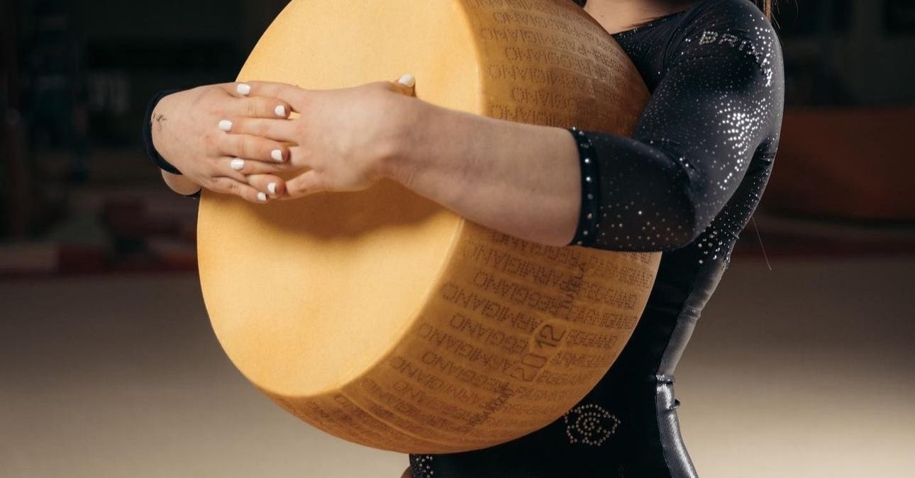 These Photos Of An Italian Gymnast Posing With Massive Wheels Of Cheese Are Going Viral