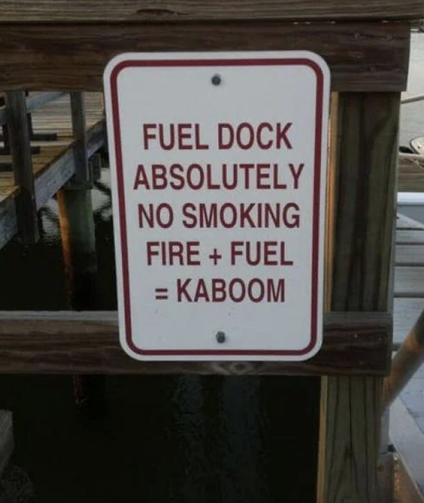 A dock sign reads: "Fuel Dock. Absolutely no smoking. Fire + fuel = kaboom."