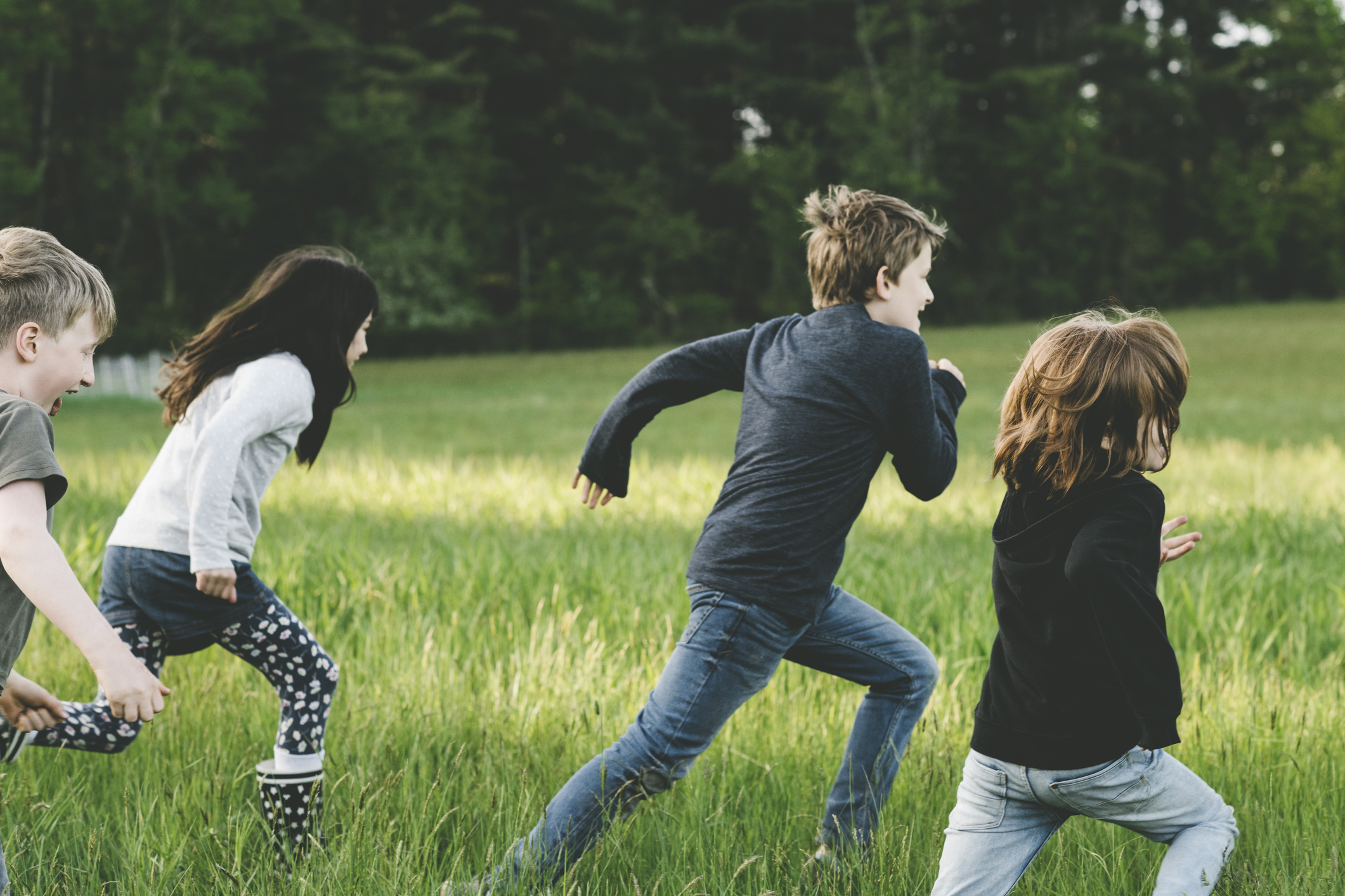 Children running on grass, enjoying outdoor playtime