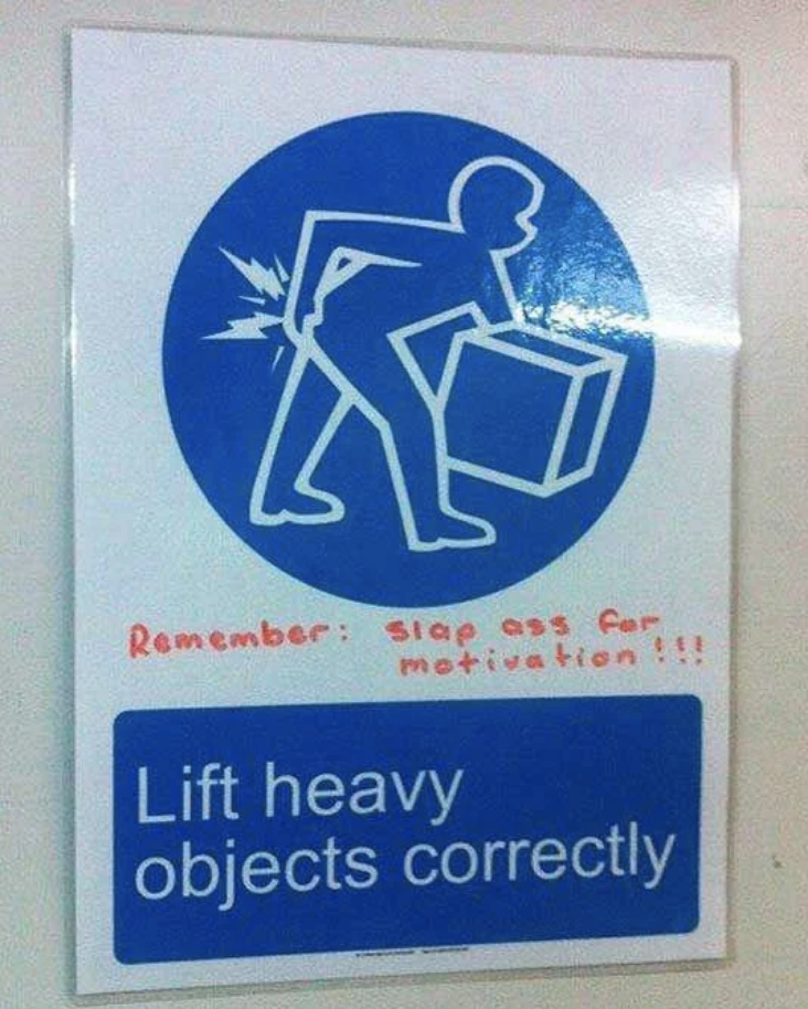 A sign shows a figure lifting a box incorrectly, leading to back pain, with the handwritten note, "Remember: slap ass for motivation!!!" The sign reads, "Lift heavy objects correctly."