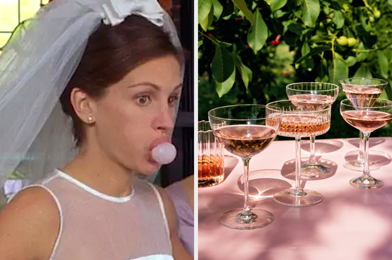 Julia Roberts, dressed as a bride with a veil and blowing a bubblegum bubble, is next to a setup of several glasses of rosé wine on a table