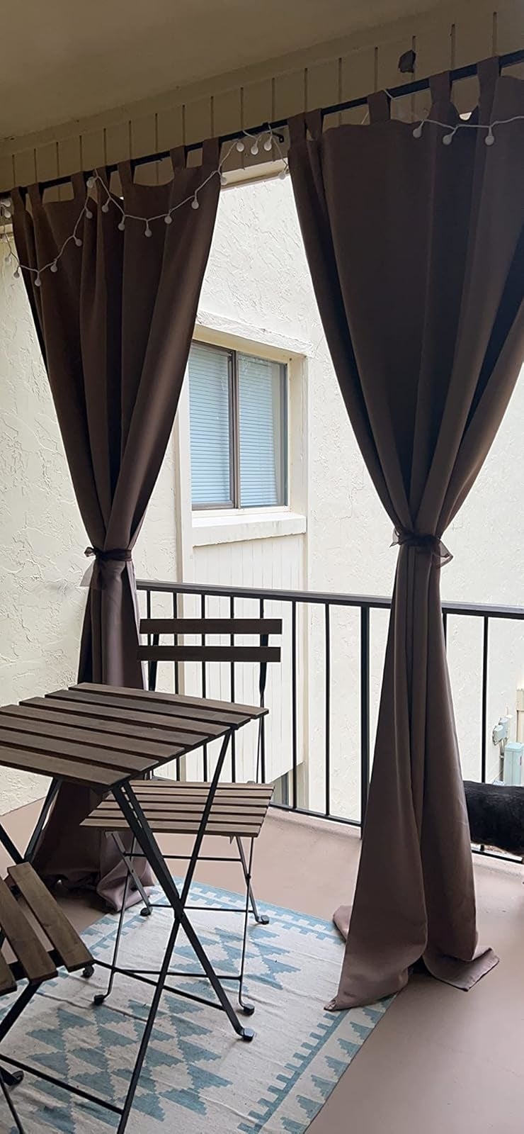 a reviewer photograph  of 2  of the curtains tied backmost  connected  a balcony