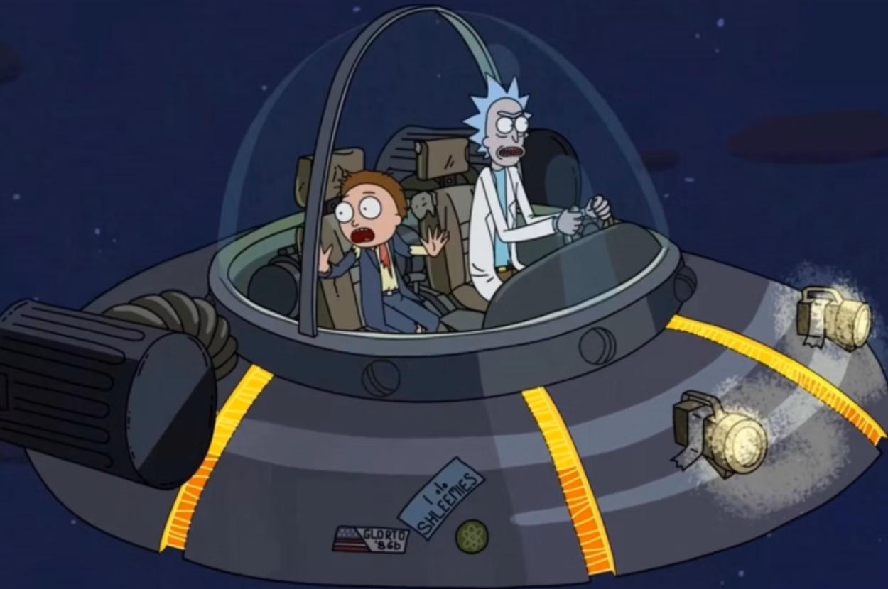 Rick and Morty are in a spaceship. Rick is piloting with an intense expression while Morty looks scared. The spaceship is flying through space