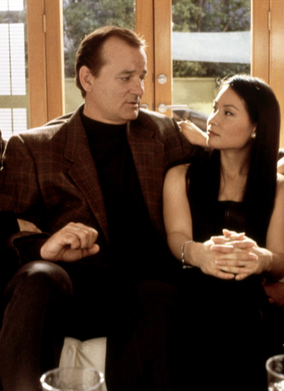 Bill Murray and Lucy Liu sit on a couch engaged in conversation in a scene