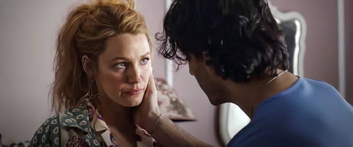 Blake Lively and Justin Baldoni share an emotional moment in a scene from a film. Drew Barrymore looks tearful as Justin Long comforts her, touching her face gently