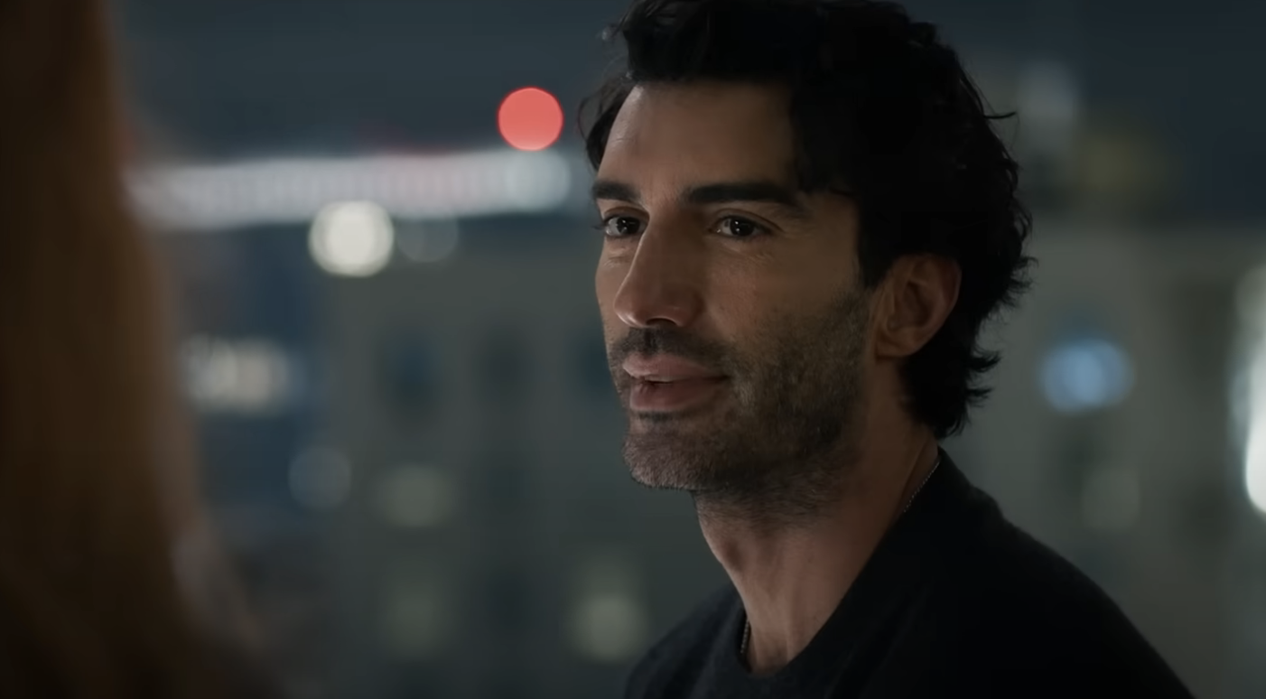 Justin Baldoni in a thoughtful moment, looking towards another person