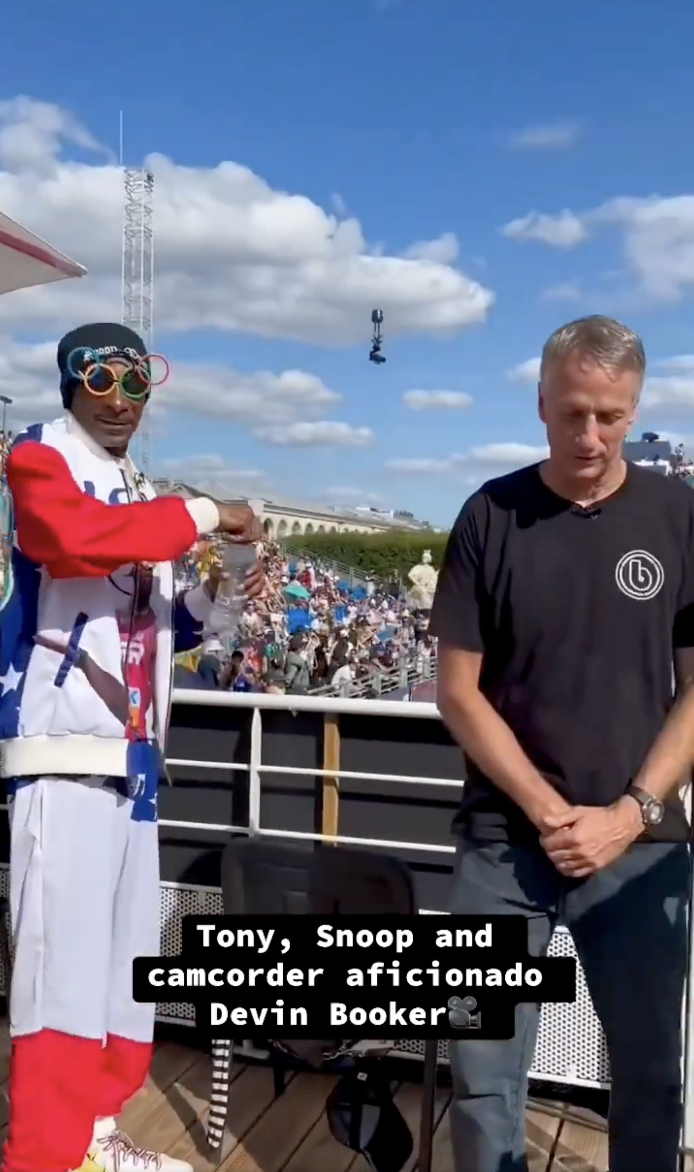 Tony Hawk, Snoop Dogg, and camcorder Devin Booker attending an outdoor event