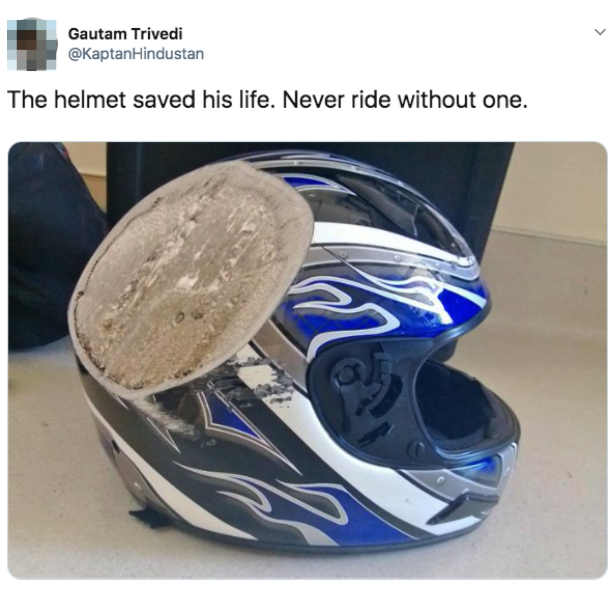 A damaged motorcycle helmet with a scraped and cracked visor is shown. Text above reads, “The helmet saved his life. Never ride without one.”