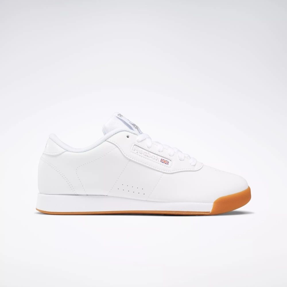 White low-top athletic sneaker with a minimalist design, featuring a gum sole. Primarily marketed for casual and everyday wear