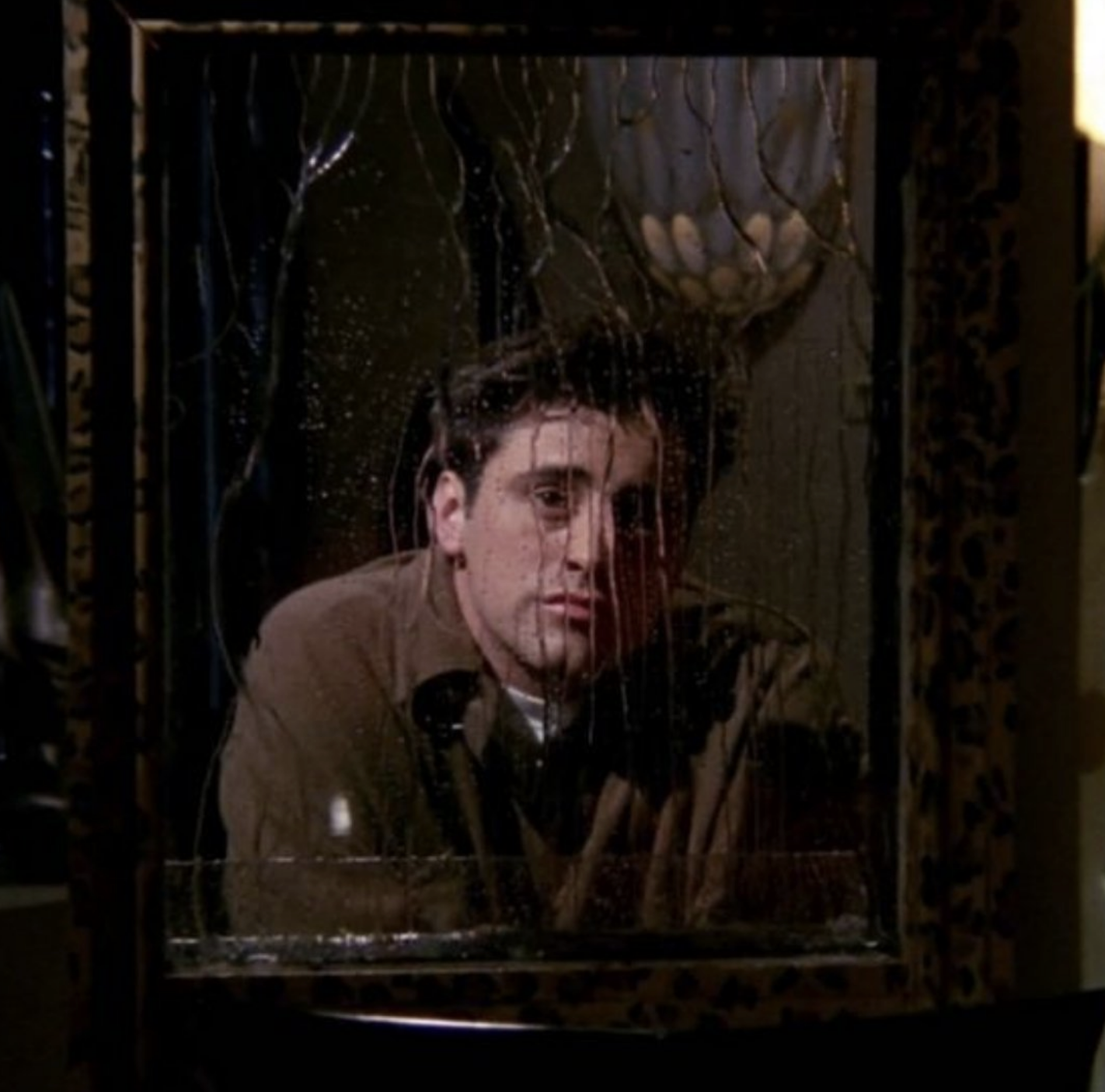 Picture of Joey Tribbiani from "Friends" gazing through a rain-covered window