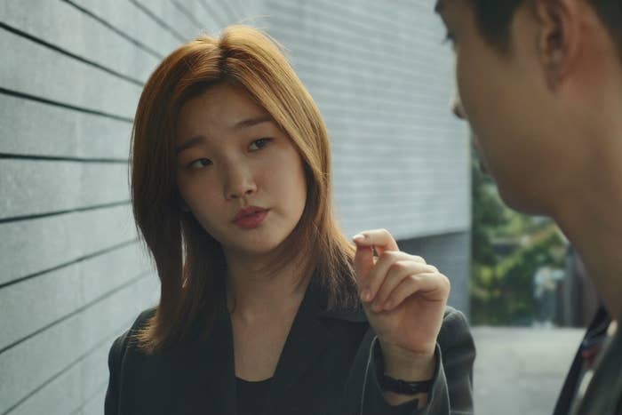 Park So-dam looks at Choi Woo-shik while holding up her hand in a scene from the film "Parasite."